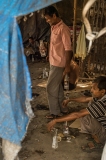 A drunk dalit workers in an illegal liquor store, near a tennery. Park Circus district.